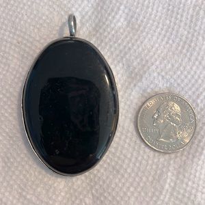 Black enamel pendant with silver back, trim and loop